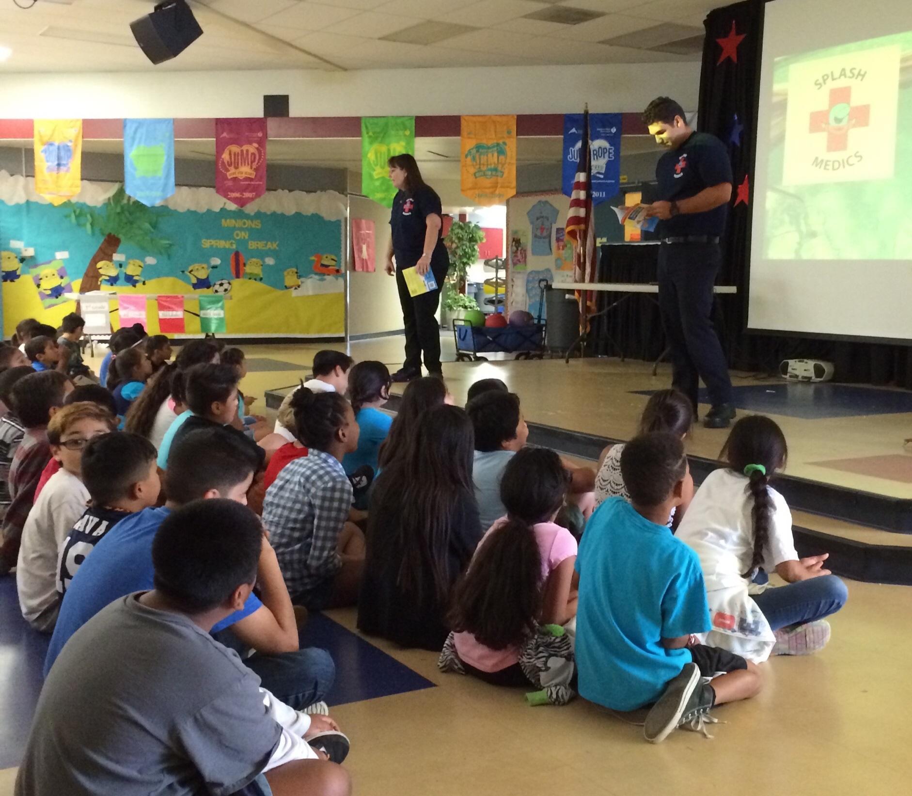 Lisa La Russo and Armando Reyes teach water safety tips to children at John Stallings Elementary in Corona, California.